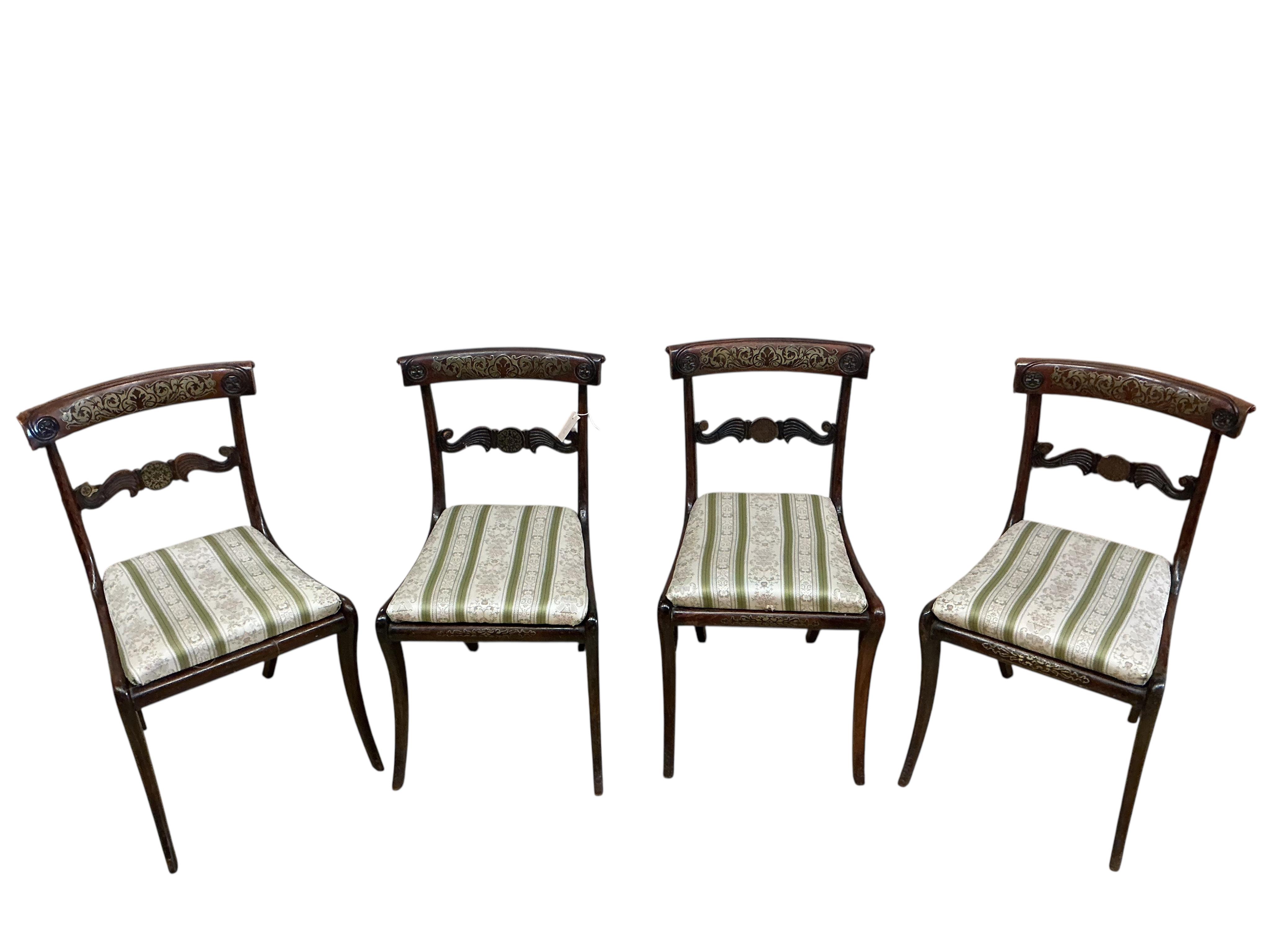 A set of four Regency brass inlaid simulated rosewood dining chairs